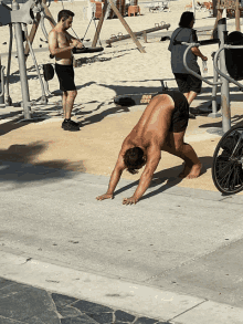 a man is doing a handstand in front of a machine that says crunch crunch