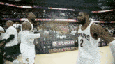 two basketball players from the cleveland cavaliers are shaking hands on the court