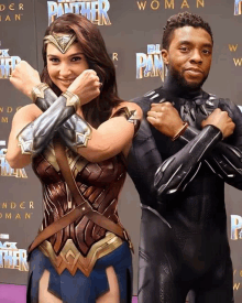 wonder woman and black panther are posing for a photo