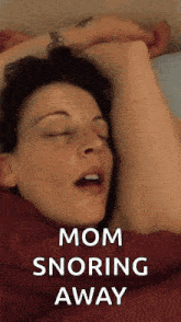 a woman is sleeping in bed with her eyes closed and the words mom snoring away above her .