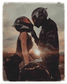 a man is putting a helmet on a woman on a motorcycle .