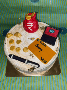 a cake with a visa card and a bag of money on it