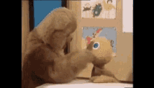 two teddy bears are playing with a stuffed animal .