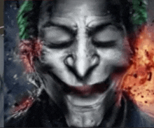 a close up of a joker 's face with his eyes closed .