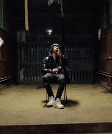 a man sitting on a chair in a dark room