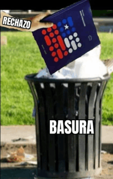 a person throws a book into a trash can with the word basura on it