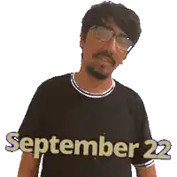 a man wearing glasses and a black shirt that says september 22 on it