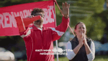 a man in a red jacket is holding a megaphone in front of a red banner that says " rent a car "