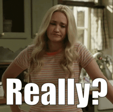 a woman with her hands on her hips is making a really ? face