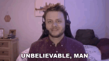 a man wearing headphones and a microphone is saying `` unbelievable , man '' while sitting in a chair .