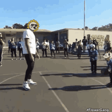 a man with a sunflower on his head is standing on a basketball court