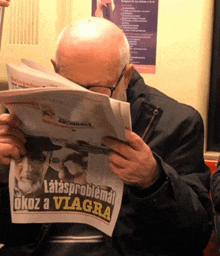 a bald man is reading a newspaper that says latasproblemat