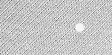 a close up of a gray knitted fabric with a white dot in the middle .