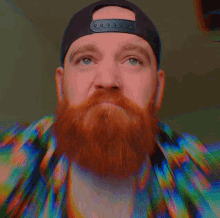 a man with a red beard wearing a hat