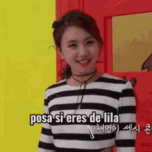 a woman wearing a black and white striped shirt is smiling and says posa si eres de lila .