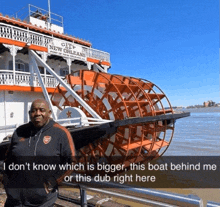 a man standing in front of a boat that says city of new orleans on it