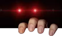 a person 's fingers are reaching out from behind a white board with red lights behind them