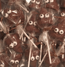 a bunch of chocolate poop shaped lollipops with googly eyes