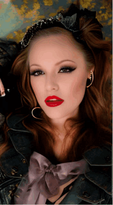 a woman with red lipstick and a black headband