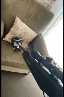 a browning rifle is sitting on a couch