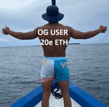 a man standing on a boat with the words og user 20e eth written on his back