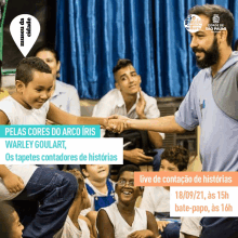 a man shakes hands with a child in front of a group of children