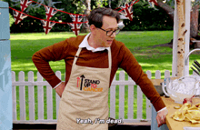 a man wearing an apron that says stand up to cancer says yeah i 'm dead