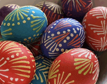 a bunch of colorful easter eggs with different designs