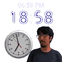 a man with glasses stands next to a clock that says 1858