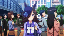 a group of people are gathered in front of a building with a sign that says ' a ' on it