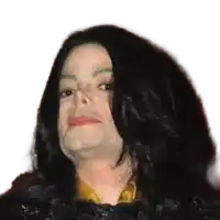 a close up of a man 's face with long black hair and a yellow shirt .