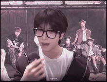 a man wearing glasses and a white shirt that says ' nct dream ' on the front