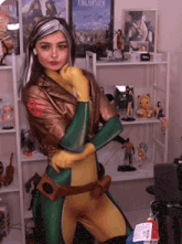 a woman in a green and gold costume stands in front of a poster for final fantasy vi
