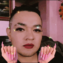 a man with fake eyelashes and pink nails