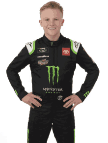 a young man wearing a monster energy outfit poses for a photo