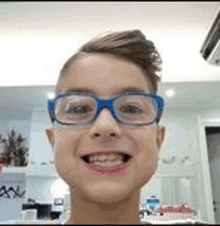 a young boy wearing glasses is smiling for a picture .