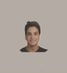 a blurred picture of a young man 's face on a white background .