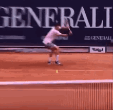 a man is swinging a tennis racquet on a tennis court in front of a sign that says generali .