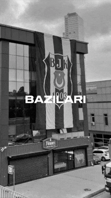 a black and white photo of a building with a flag that says bjk