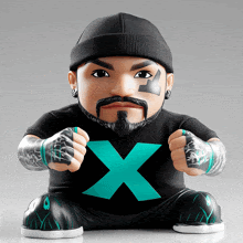 a figurine of a man with a beard is wearing a black shirt with a blue x on it