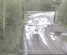 a black and white photo of a muddy road with the words `` story of my life '' written on the bottom .