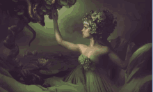 a woman in a green dress with flowers in her hair reaches for something