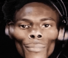 a close up of a man 's face with headphones on .