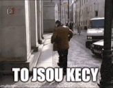 a man is walking down a street with the words to jsou kecy written on the bottom