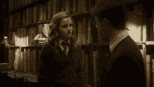 harry potter and hermione granger are in a library talking to each other