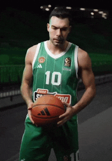 a basketball player in a green jersey with the number 10 on it