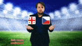 a man in a suit stands in front of a stadium with a georgian flag and a czech flag on his chest