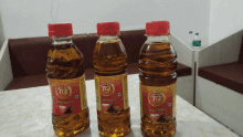 three bottles of tg oil are on a table