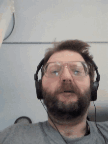 a man with a beard wearing headphones and goggles