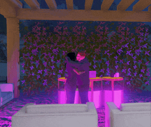 a man and woman are hugging in front of a wall with purple flowers